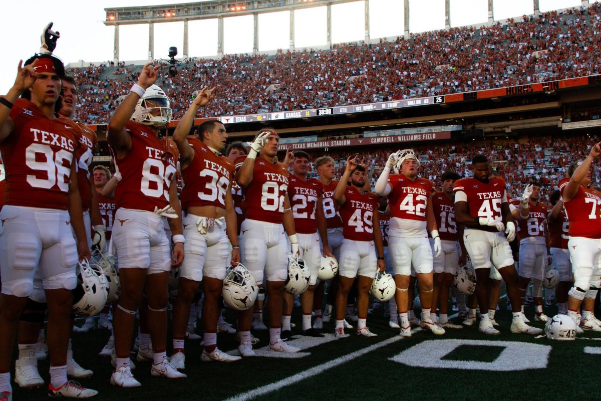 The Longhorns sing the Eyes of Texas with the student section after their win against the Jayhawks on Sept. 30, 2023. 