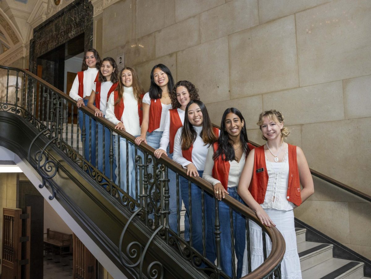 (From left) Texas Orange Jacket officers Social Director Marylynn Alvarado, PR Director Christine Camarillo, Special Events Director Athena Adrogué, Alumni Relations Director Rachel Chen, Co-Vice President of Membership Mia Weissbluth, Co-Tap Trainer Annie You, Settlement Home Director Nikita Kakkad, President Anna Alvis inside the UT Tower on Oct. 31, 2023.