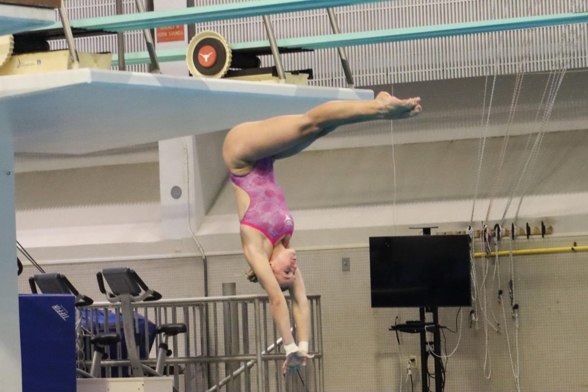 Freshman+Caroline+Kupka+dives+off+the+10-meter+platform+and+into+the+pool+on+Nov.+3%2C+2023.+Kupka+placed+first+with+a+score+of+295.35+points.