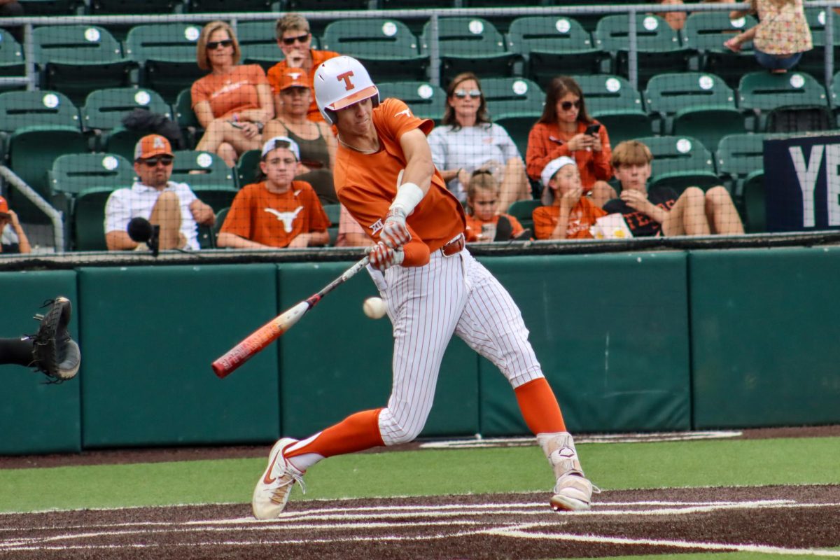 Freshman outfielder Will Gasparino swings and hits the ball at game three of the Fall World Series on Nov. 5, 2023. Earlier in the game Gasparino hit a home run for the orange team.