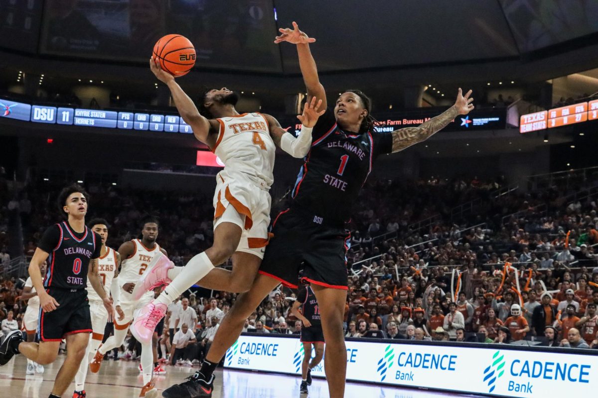 Junior+guard+Tyrese+Hunter+jumps+with+the+ball+toward+the+hoop+as+an+opponent+from+Delaware+State+attempts+to+block+him+on+Nov.+10%2C+2023.+Hunter+scored+13+points+for+the+Longhorns+in+this+game%2C+contributing+to+the+86-59+victory.