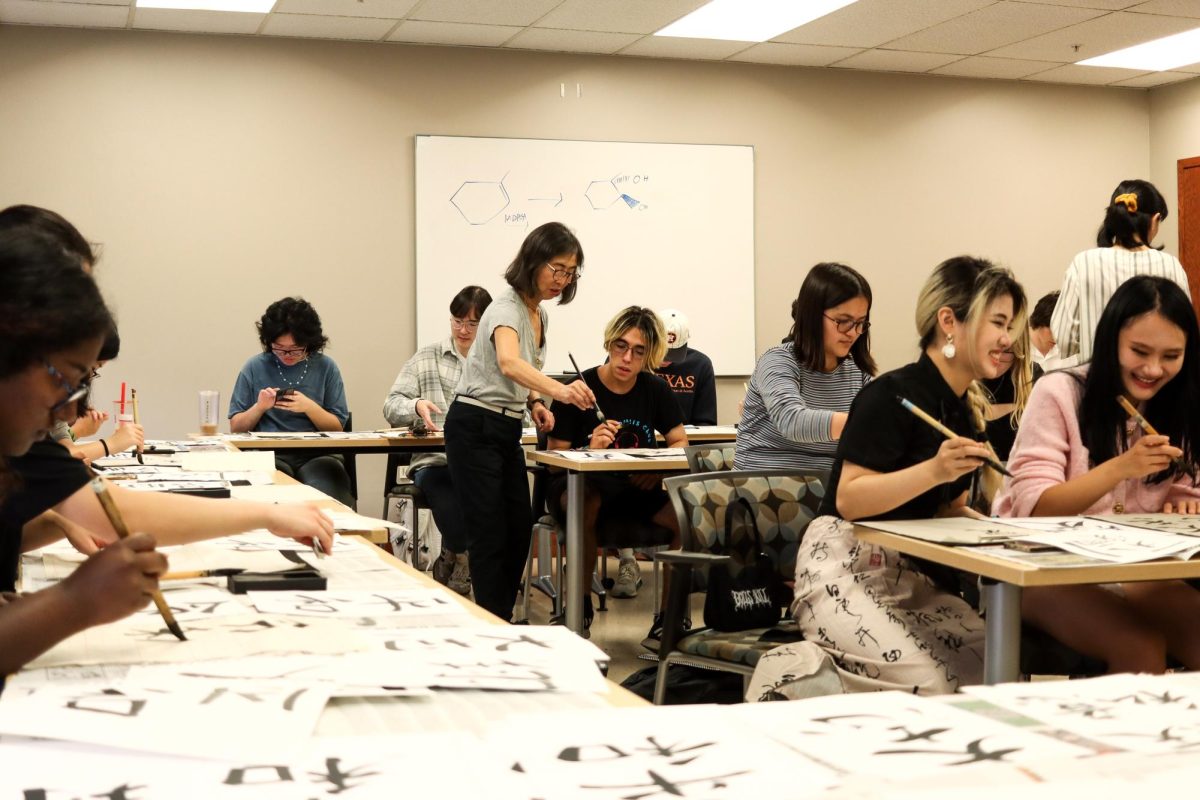 Tomoko Hetherington teaches Japanese calligraphy in the EP Schoch Building to Senior Japanese and Math major Samuel Davila-Vega on Nov. 7, 2023. While this was not Davila-Vega’s first time learning, it was for many others.