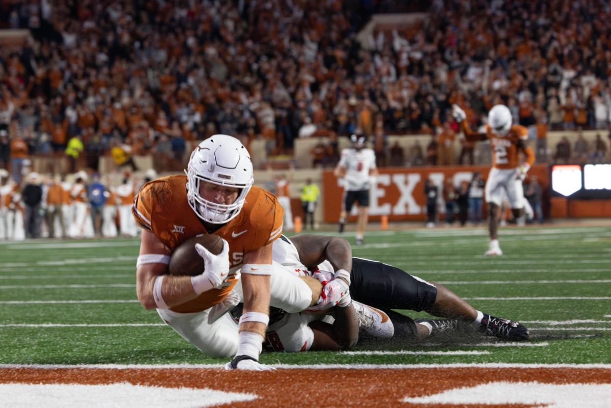 Linebacker Jett Bush scores a touchdown for the Longhorns after intercepting the ball during the game against Texas Tech on Nov. 24. 