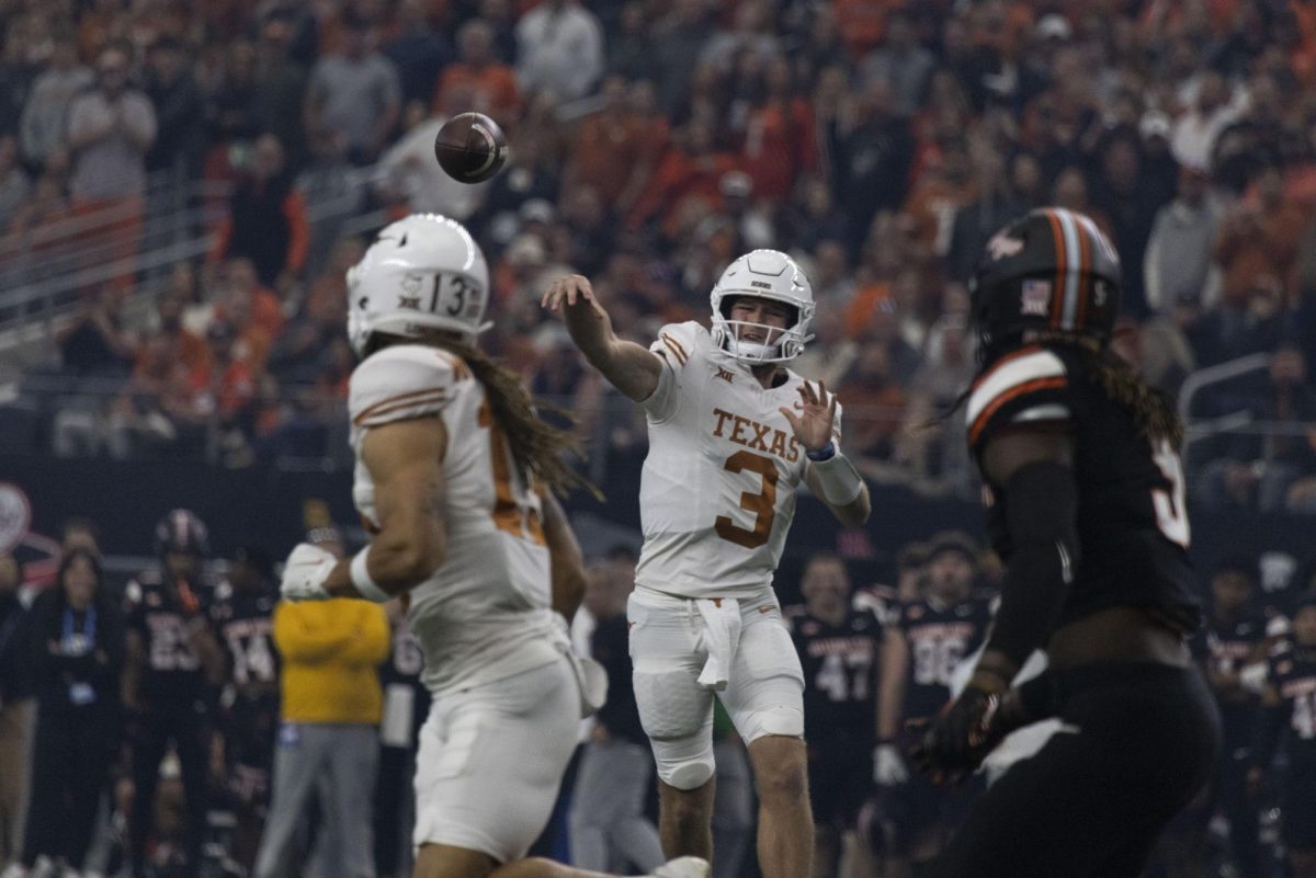 Quarterback Quinn Ewers throws the ball during Texas game against OSU during the Big 12 Championship on Dec. 2, 2023. Ewers broke the record for most passing yards in the Big 12 Championship game.