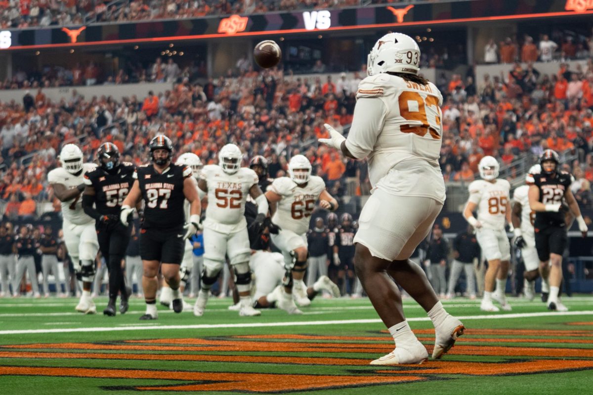 Defensive lineman TVondre Sweat scores a touchdown during the Big 12 championship game on Dec. 2. It was the first touchdown of his career at UT. 