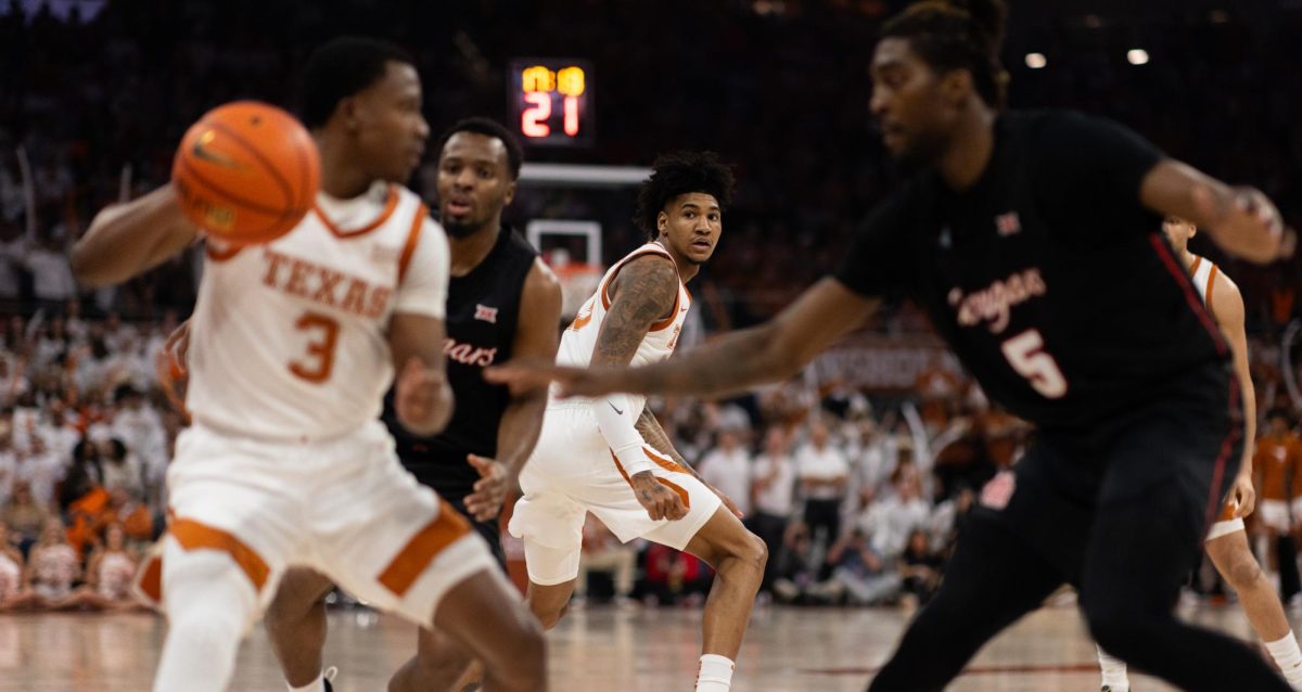 Forward Dillon Mitchell looks for Max Abmas play during Texas game against Houston on Monday. Texas lost in overtime 76-72.