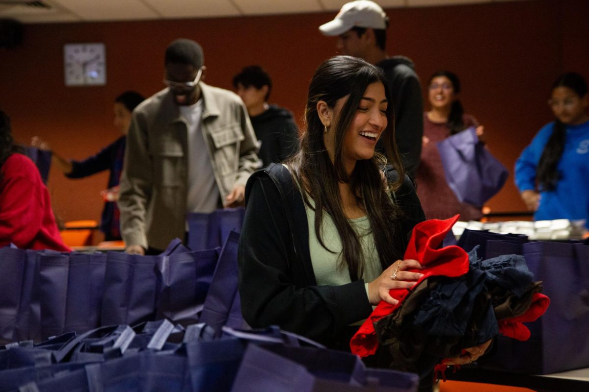 A student distributes supplies at UT UMRs Project Downtown event on Feb. 7, 2024. The UT chapter of the organization focuses on local and international humanitarian causes. 