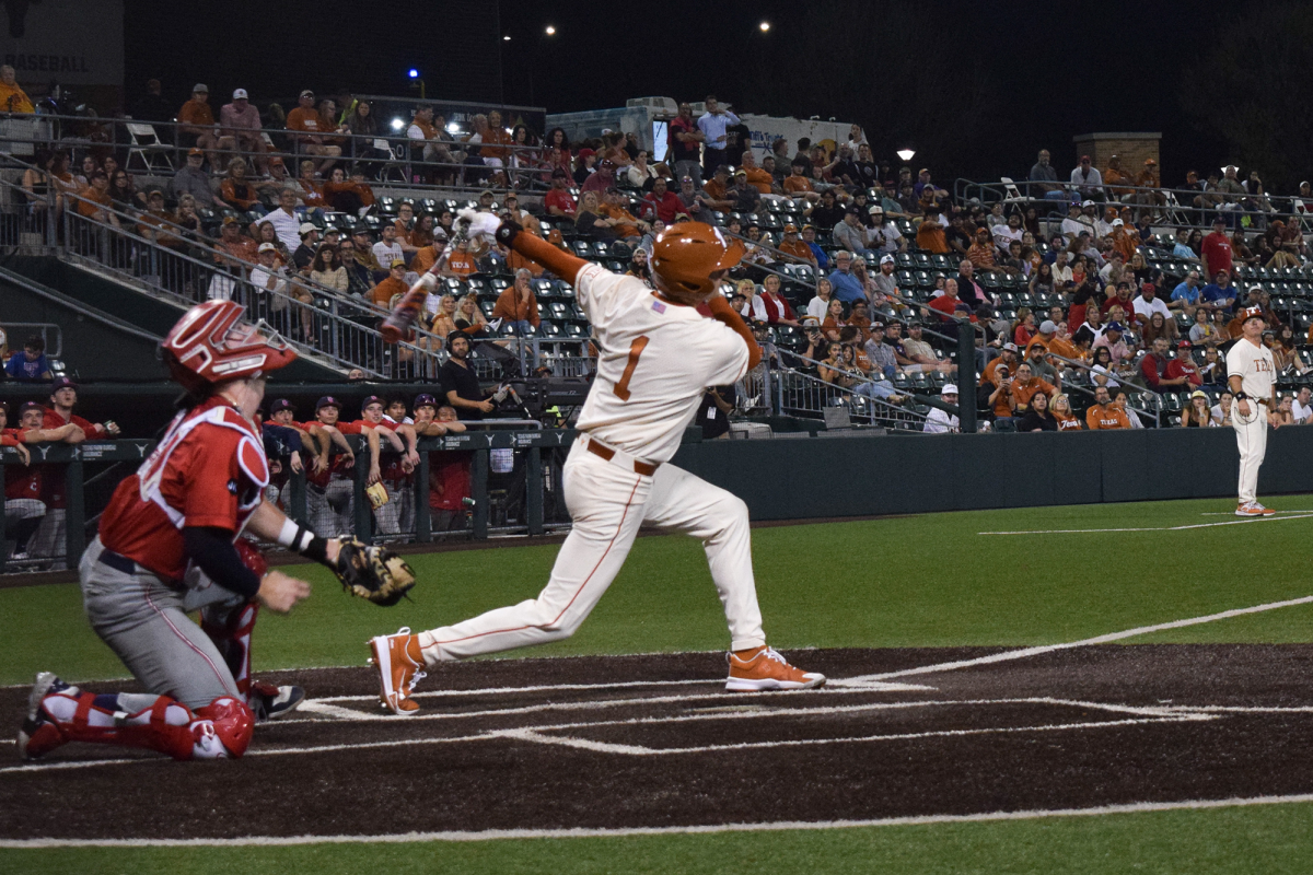 Jalin Flores swings a grand slam in the fourth inning, putting Texas in the lead against St Johns University on Feb 25, 2024.