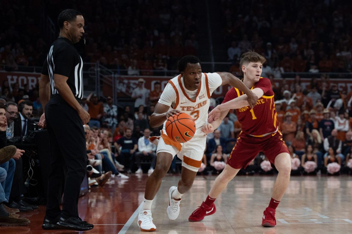 Guard Max Abmas dribbles past an opposing player during Texas game against Iowa State on Feb. 6, 2024. Abmas recently became the 12th player in college basketball history to score 3,000 career points. 