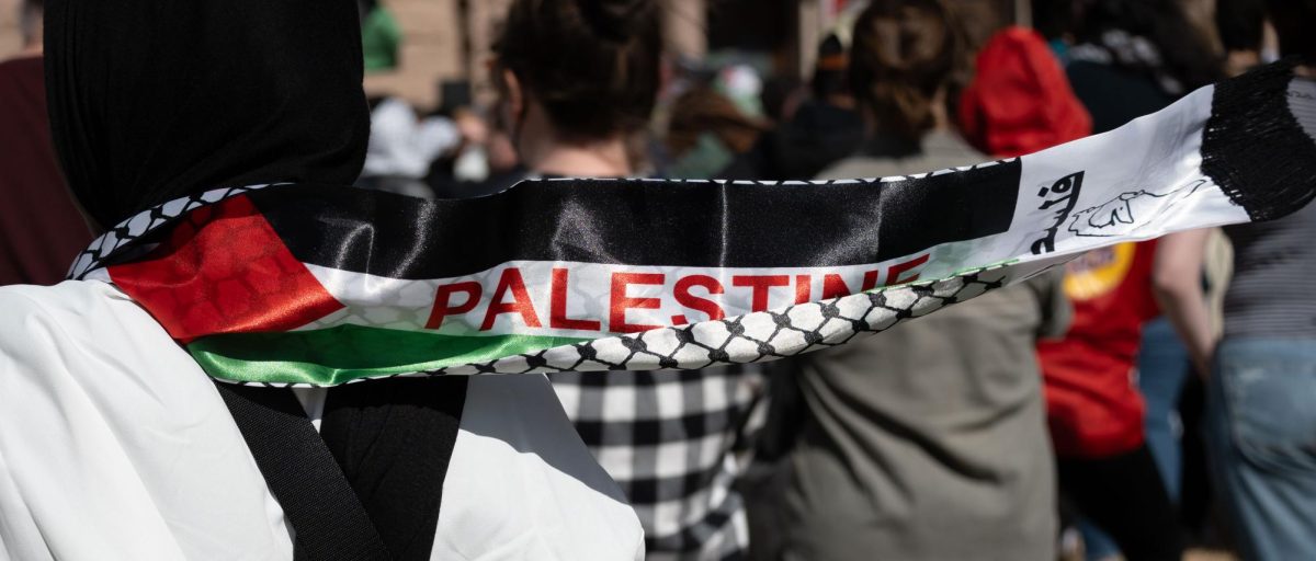 A person wears a Palestinian flag as protestors rally at the Capitol in support of a ceasefire in Gaza on Sunday.