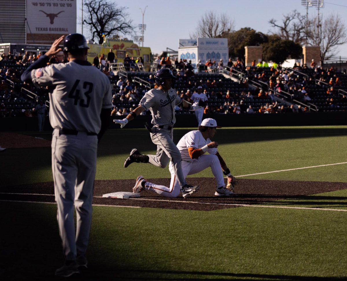 A San Diego player makes it to first base during the game at Disch-Falk Field on Friday.