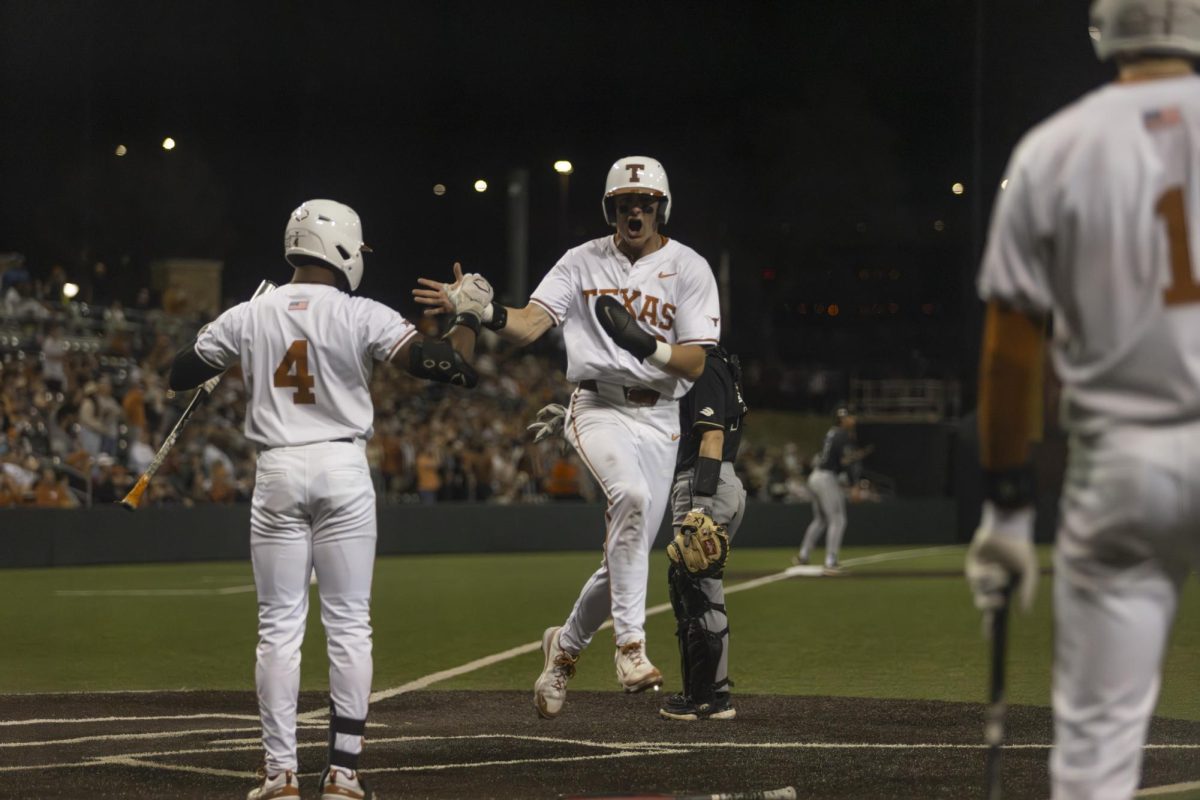 Jared Thomas celebrates a completion to home base during Texas first game in the series against Cal Poly on Feb. 23, 2024. Texas won 2-0.