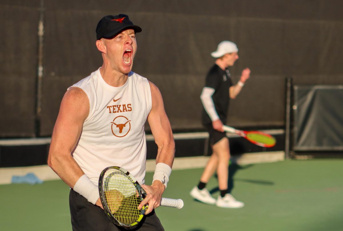 Redshirt senior Cleeve Harper shouts after scoring a point on January 18, 2024. Harper and doubles partner Eliot Spizzirri won their doubles match against Virginia.