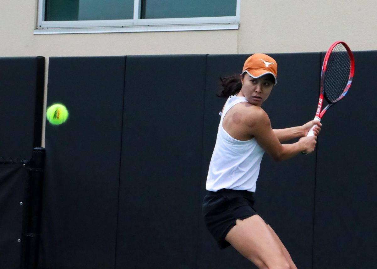 Senior+Charlotte+Chavatipon+stares+at+the+ball+while+preparing+to+hit+on+January+26%2C+2024+against+Baylor.+Chavatipon+defeated+her+opponent+in+singles+play+6-1%2C+6-1.+