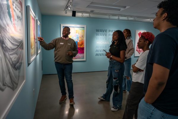 Phillip Townsend, UTs Curator of Art at Art Galleries at Black Studies, walks students through the exhibition “Wave Patterns” by Michael Booker at the Idea Lab on Jan. 31, 2023.