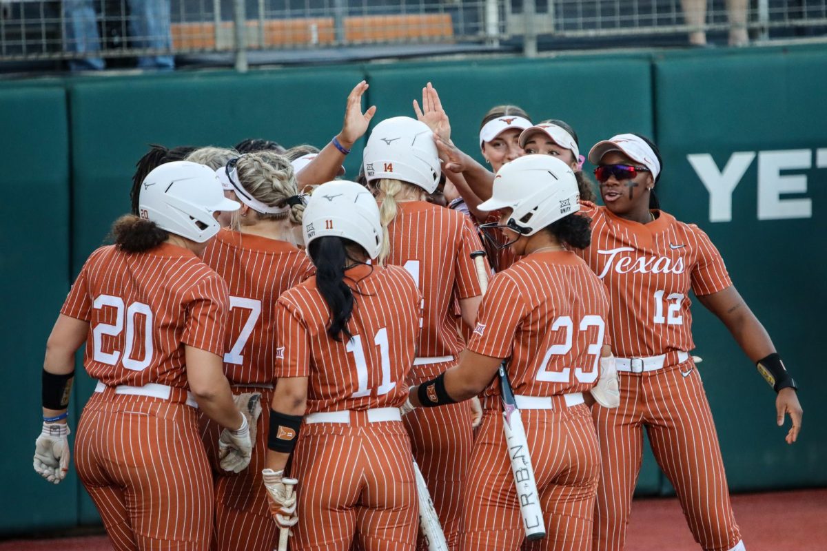 Sophomore catcher Reese Atwood is surrounded by her teammates being celebrated after hitting a home run on Wednesday. Atwood finished the game against Houston Christian University with 3 hits and 1 run to contribute to the Longhorns 14-1 win.