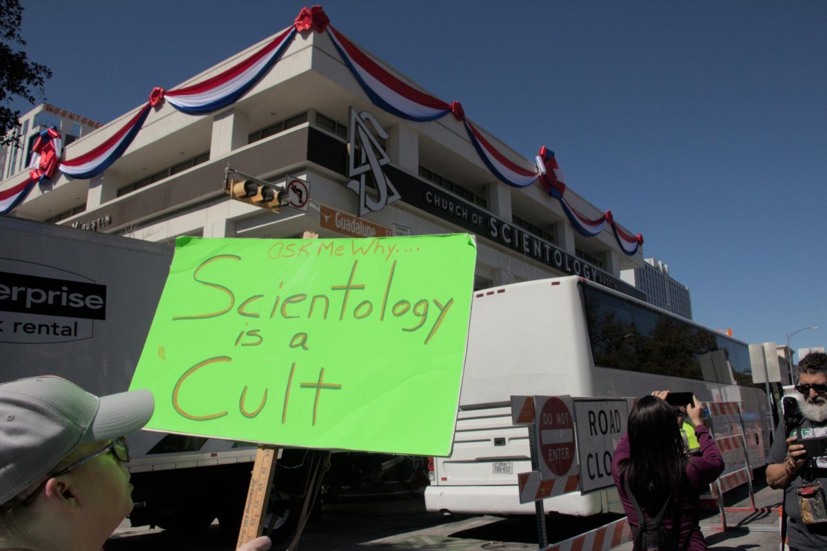 Protestors chant slogans and wield signs against the reopening of the Scientology Church on Feb. 24. The protestors came from different cities in Texas and states to protest the reopening of the Scientology Church building on Guadalupe Street, citing the organization commits acts of extorsion, child trafficking, mistreatment of members, and more.