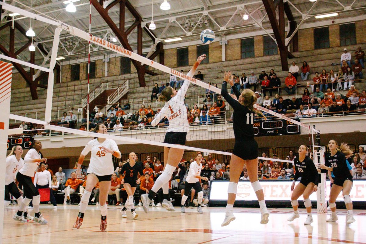 Sophomore Ella Swindle tips the ball over the net on Thursday, Feb. 29, 2024 during the game against Texas State. The Longhorns swept the Bobcats, winning 3-0.