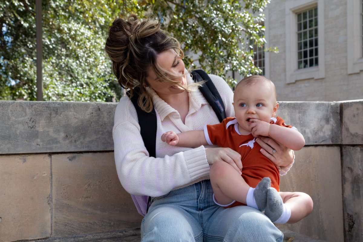 Public relations senior Kaylee Gustin holds her son, Aiden, on campus on Saturday. “(Before I was a parent), I would sleep in until 20 minutes before my class and I would run down here and do the bare minimum,” Gustin said. “Now, I have to make the best grades possible because we’re trying to build this future and our money depends on it.”