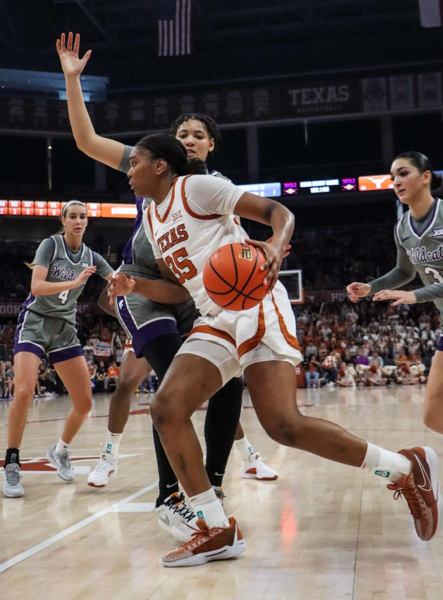 Freshman forward Madison Booker pushes past opponents towards the net on Feb. 4, 2024. Booker scored 20 points to lead the Longhorns to a 61-54 upset win over the Kansas State Wildcats.