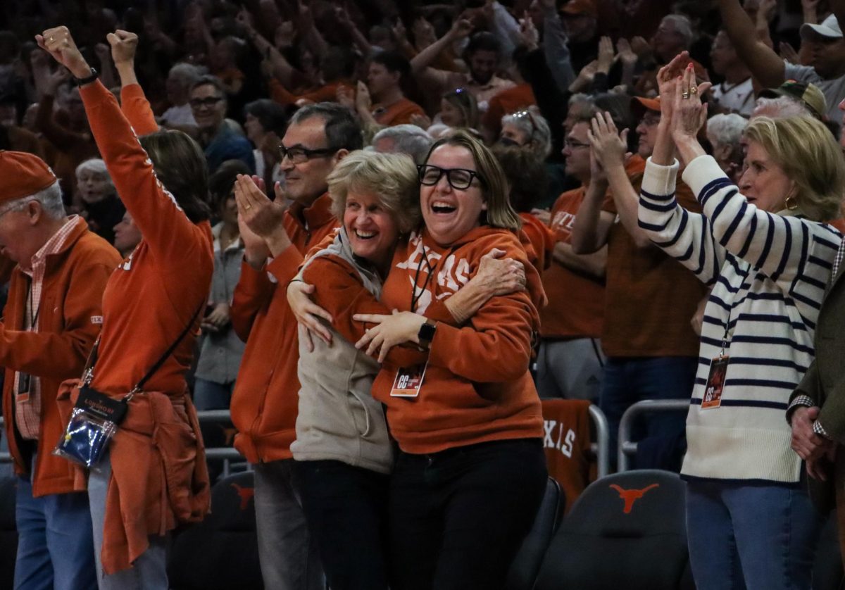 Texas+alumni+hug+as+the+buzzer+sounds+to+end+the+game+against+Kansas+State+on+Sunday.+The+Longhorns+defeated+the+%232+ranked+Wildcats+61-54.