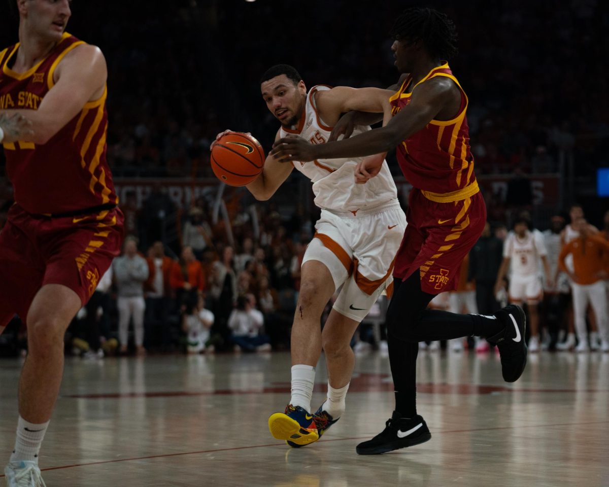 Forward+Dylan+Disu+dribbles+the+ball+during+the+Texas+mens+basketball+game+against+Iowa+State+University+on+Feb.+6%2C+2024.+The+Longhorns+lost+the+game+70-65.