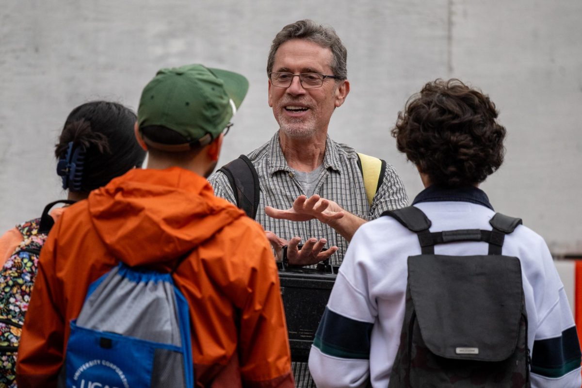 Professor Jay Banner guides his science of environmental justice class through testing the water quality of Waller Creek on East 23rd Street on Feb. 2.