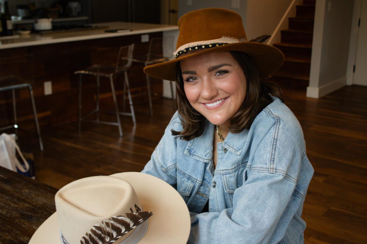 Sidney+Tillotson%2C+founder+of+Custom+Crown+Hats%2C+smiles+after+creating+a+hat+in+her+studio+on+Thursday.