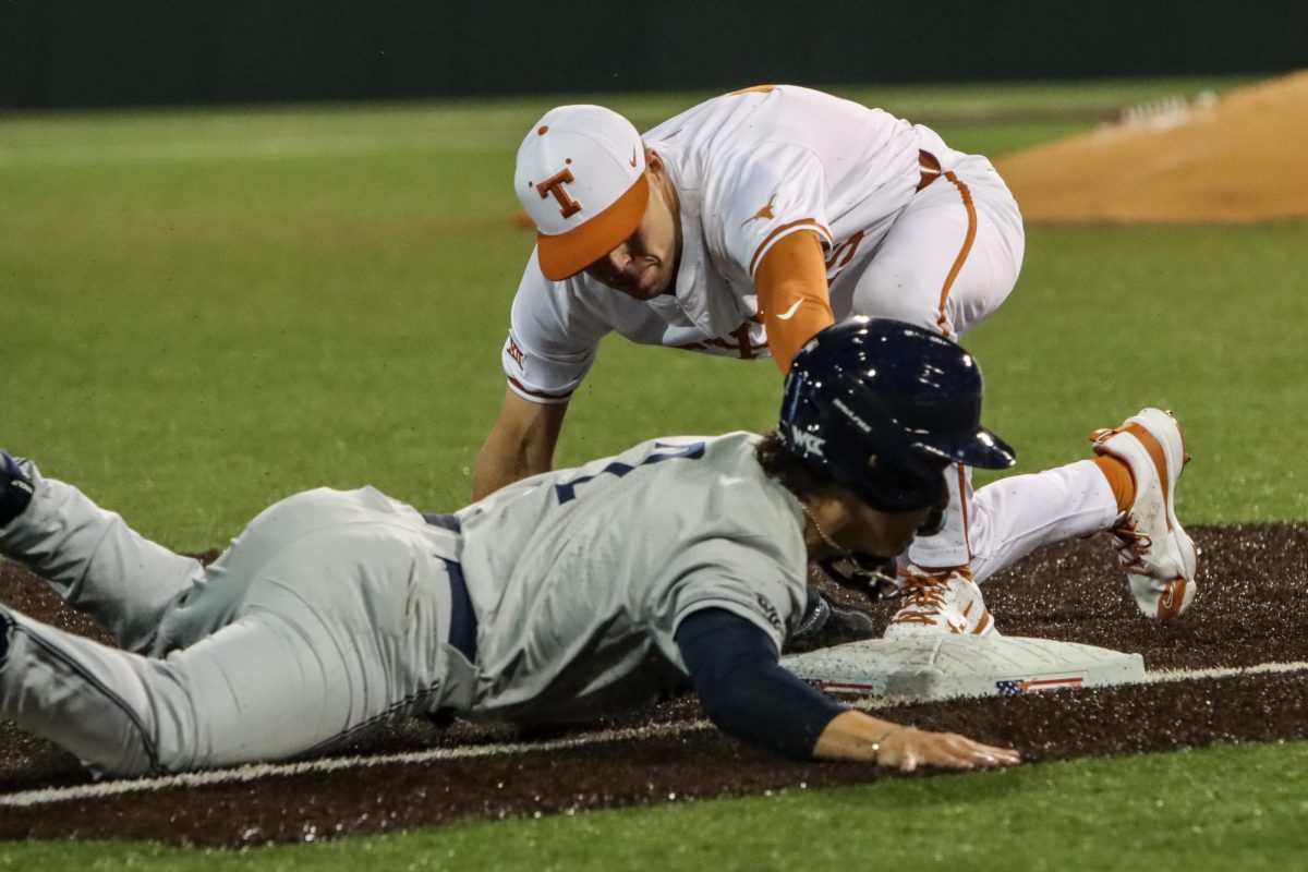 Redshirt senior Peyton Powell tags the San Diego runner out as he slides into third base on February 16, 2024. Powell finished the game with 2 hits and 1 run helping the Longhorns defeat the Toreros 7-3.