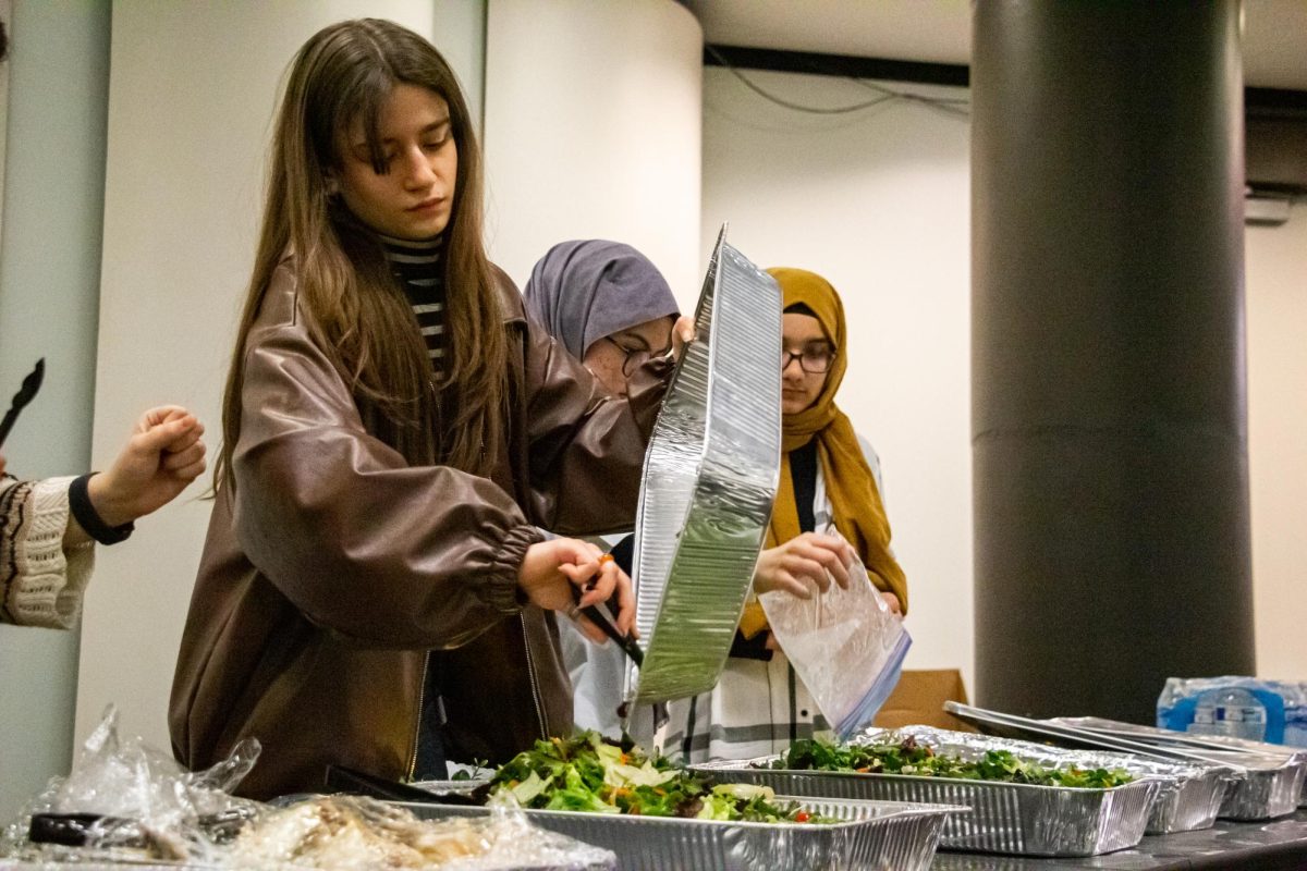 Members of the Dialogue Student Association prepare an assortment of salad for attendees who were fasting for Ramadan at the George I. Sánchez building on March 26, 2024. The Muslim holy month of Ramadan begins with abstraining from food since dawn, breaking the fast at sunset.