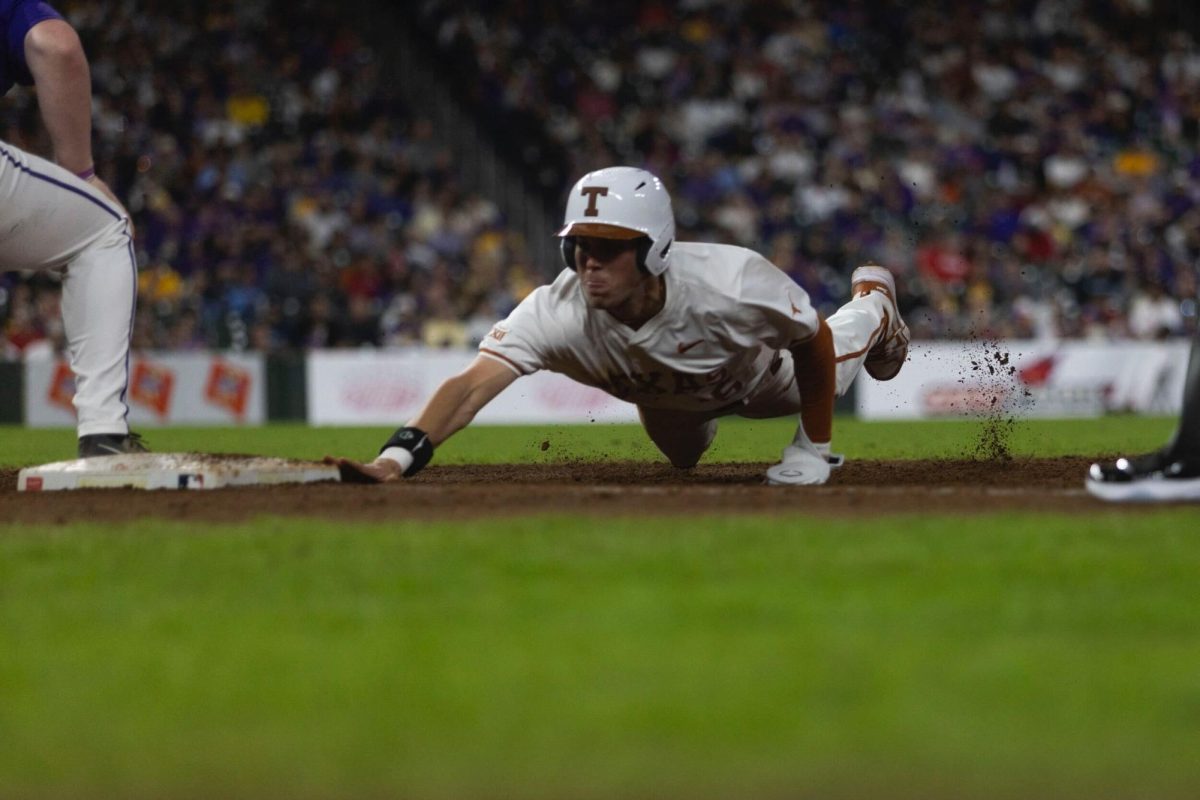 Utility Peyton Powell slides back to first during Texas game against LSU on March 1, 2024. The Longhorns lost to the Tigers 6-3.