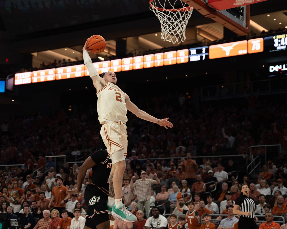 Guard Chendall Weaver prepares to dunk the ball during Texas’ game against Oklahoma State on March 2, 2024. Weaver scored with 16 points in the Longhorns win over the Cowboys. 