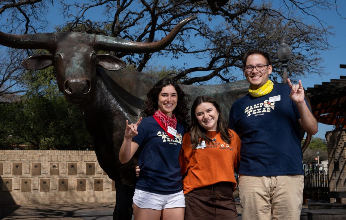 Camp Texas Counselors (from left to right) Mateen Lindsay, Nina Alvarez and Saúl Compean stand for a portrait in front of a bronze Bevo statue at the Etter-Harbin Alumni Center on Friday, March 1, 2024.