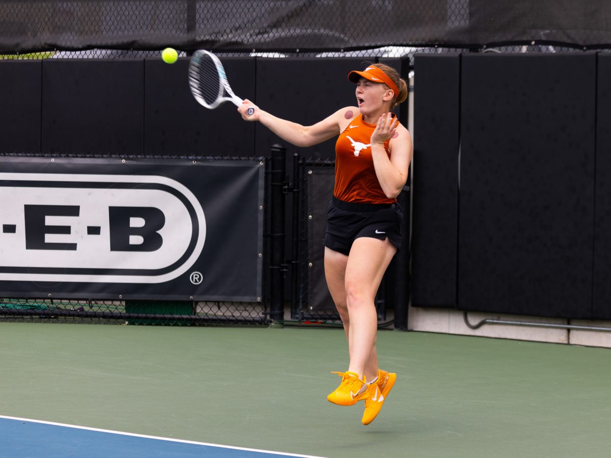 Taisiya+Pachkaleva+jumps+to+hit+an+incoming+ball+during+a+match+against+Kansas+State+University+on+March+24%2C+2024.+The+Longhorns+swept+the+Wildcats+4-0.
