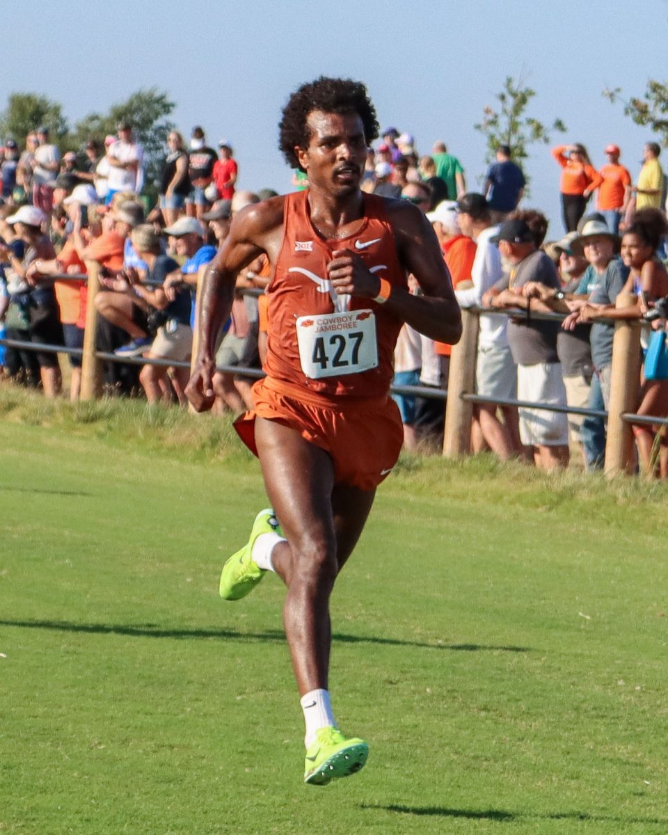 Graduate student Haftu Knight runs the last stretch of the 8000-meter course on Sept. 23, 2023. At the Cowboy Jamboree meet, Knight finished in seventh place with a time of 24.14.3.