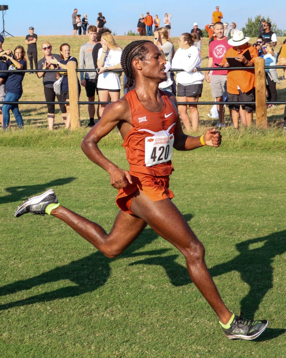 Junior Nigusom Knight runs towards the finish line at the Cowboy Jamboree meet on Sept. 23, 2023. Knight finished 28th with a time of 25:50.8 in the 8000-meter race.