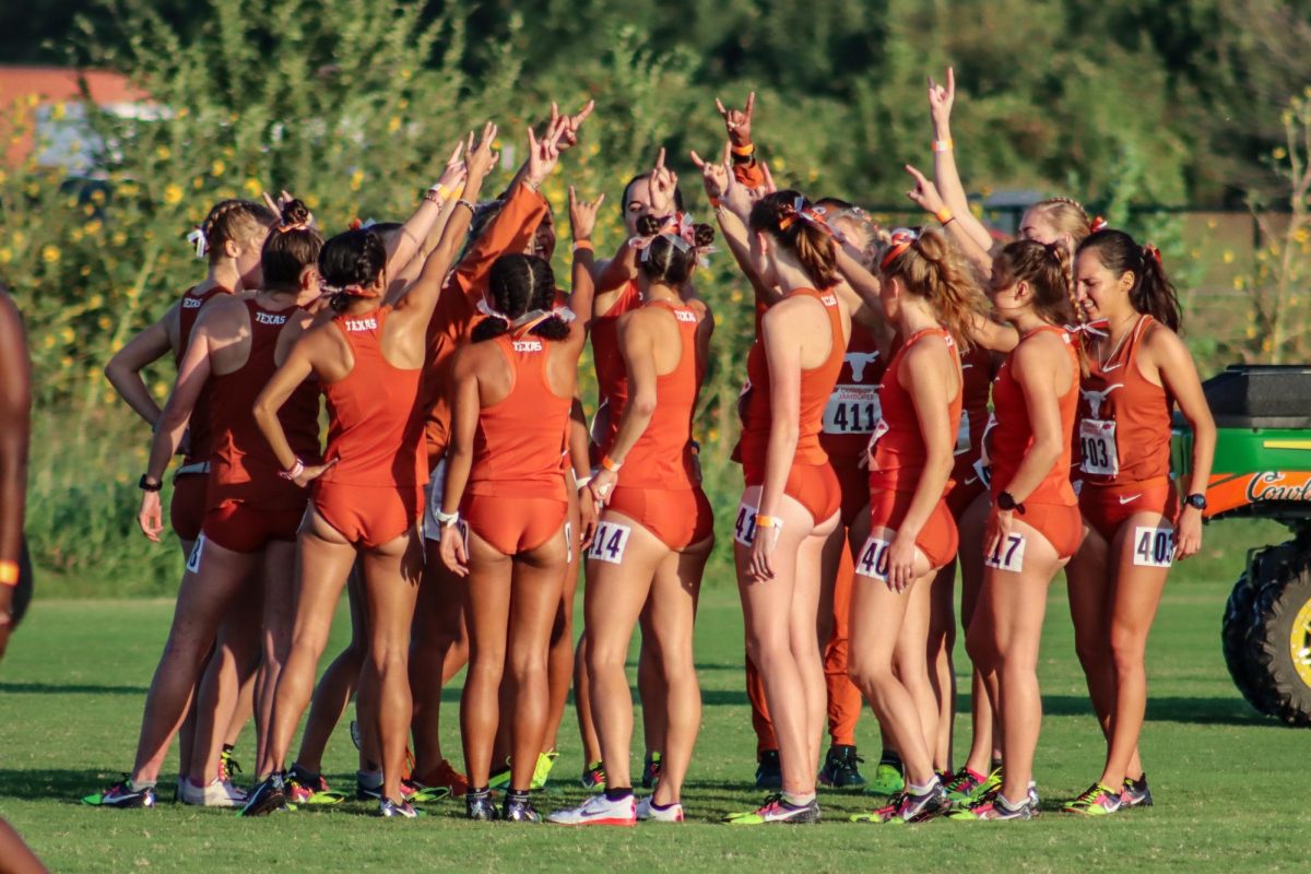 The+womens+Track+%26+Field%2FCross+Country+team+chants+before+heading+to+the+starting+line+at+the+Cowboy+Jamboree+Meet+on+September+23%2C+2023.+The+Longhorns+placed+second+as+a+team+with+a+score+of+52+points.