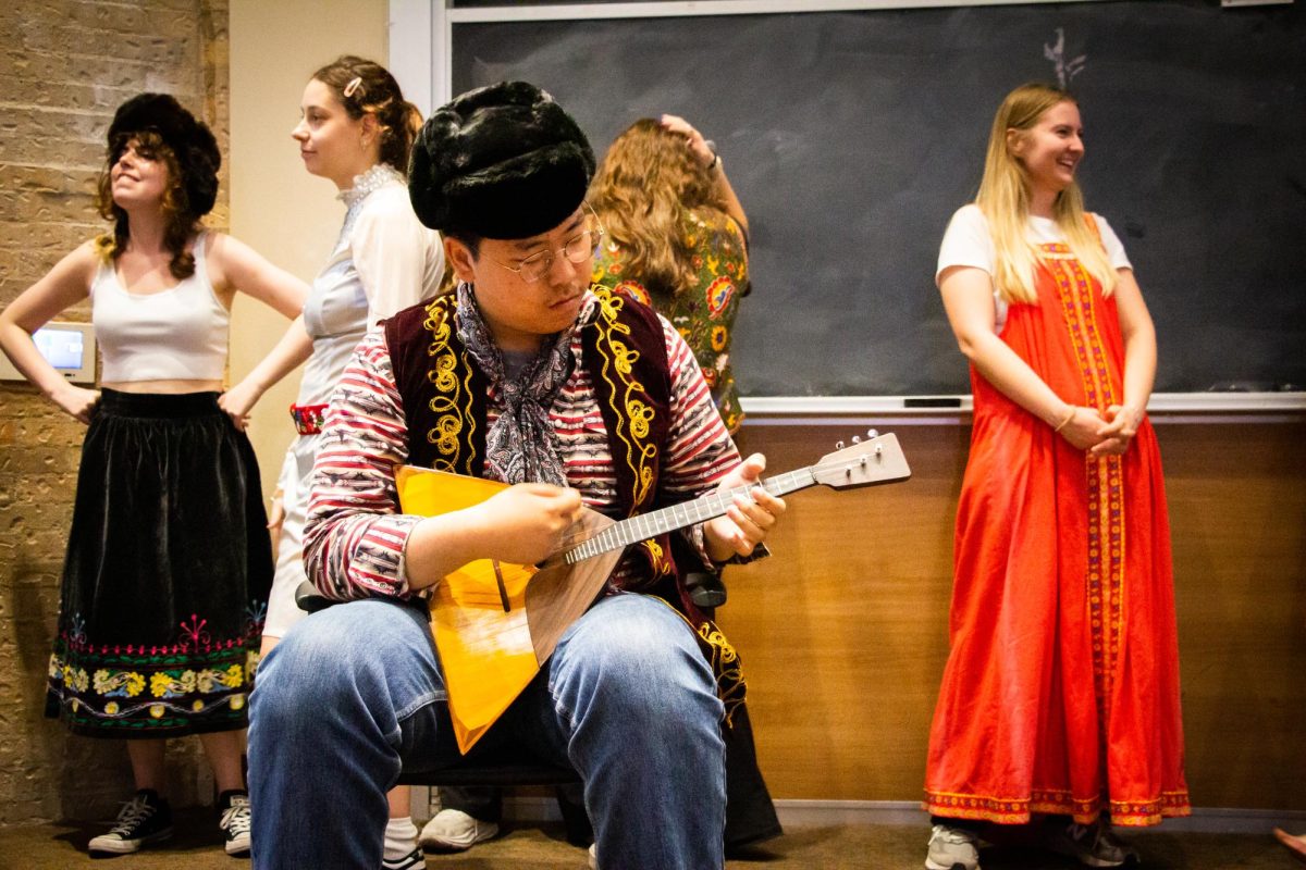 Linguistic major Hongli Zhang starts to strum a balalaika in preparation of a slavic dance performance at the Jester dormitories auditorium on April 1, 2024.