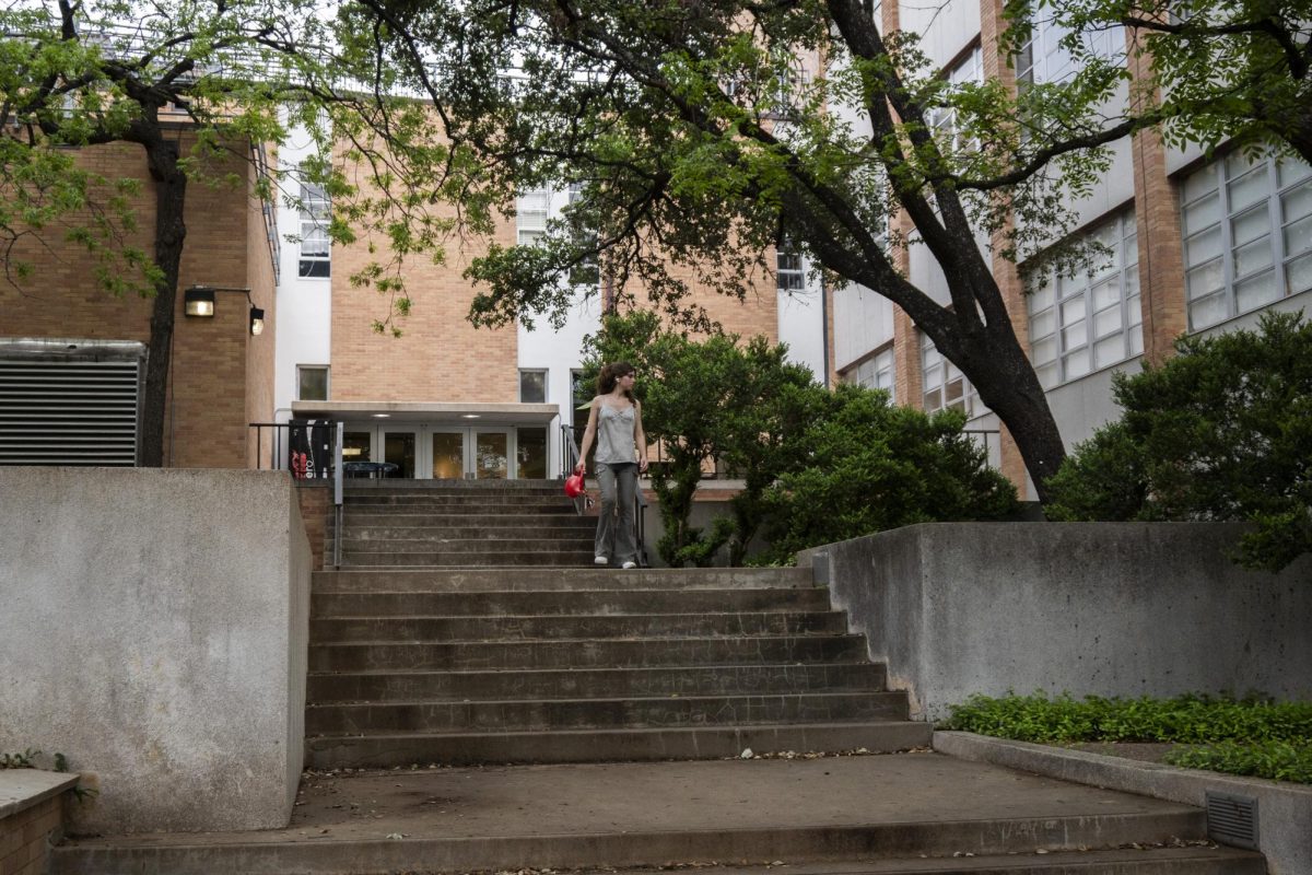 A student walks down the Art Building stairs on San Jacinto Boulevard on Monday.