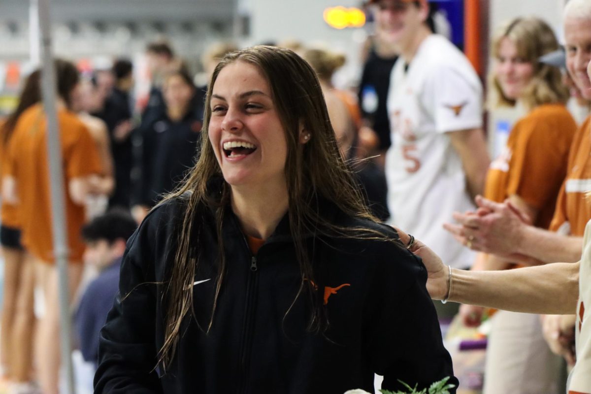 Senior+Emma+Sticklen+smiles+as+she+gets+recognized+at+the+Senior+Day+meet+against+TCU+on+Feb+2%2C+2024.