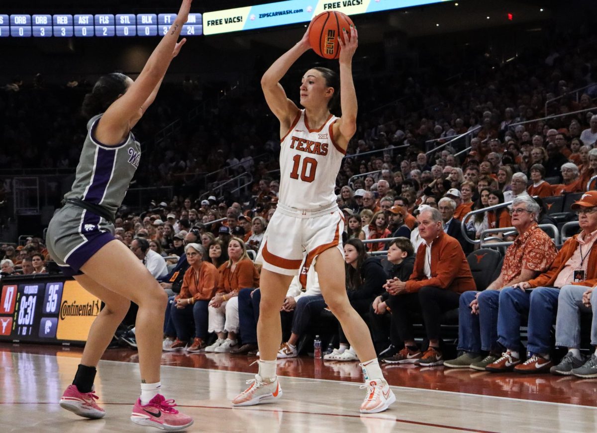 Senior Shay Holle keeps the ball away from an opponent on Feb. 4, 2024 at Texas game against Kansas State.  