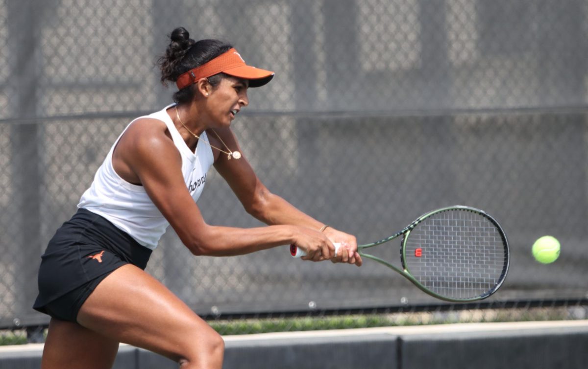 Senior+Malaika+Rapolu+lunges+to+hit+the+ball+during+singles+against+Oklahoma+on+March+3%2C+2024.+Rapolu+defeated+Ava+Catanzarite+6-2%2C+6-2%2C+to+help+the+Longhorns+defeat+the+Sooners.