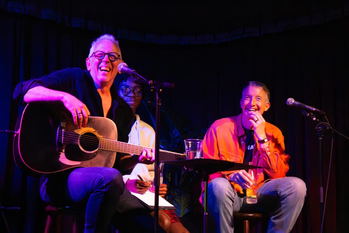 President+Jay+Hartzell+and+songwriting+Texas+Ex+Darden+Smith+laugh+during+a+presidential+song+writing+performance+on+April+10%2C+2024.+The+first-of+its-kind+event+was+held+in+the+Cactus+Cafe.