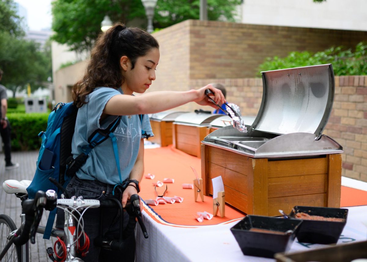 Junior chemical engineering major Gaby Bastidas collects a free taco provided by Parking and Transportation Services outside the Perry-Castañeda Library during the Bike to UT Day event on April 16, 2024. Tacos and coffee were offered to the first 200 registered cyclists who showed up.