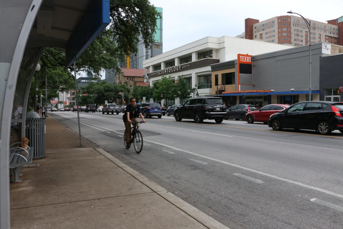 A person bikes on Guadalupe Street on April 17, 2024.