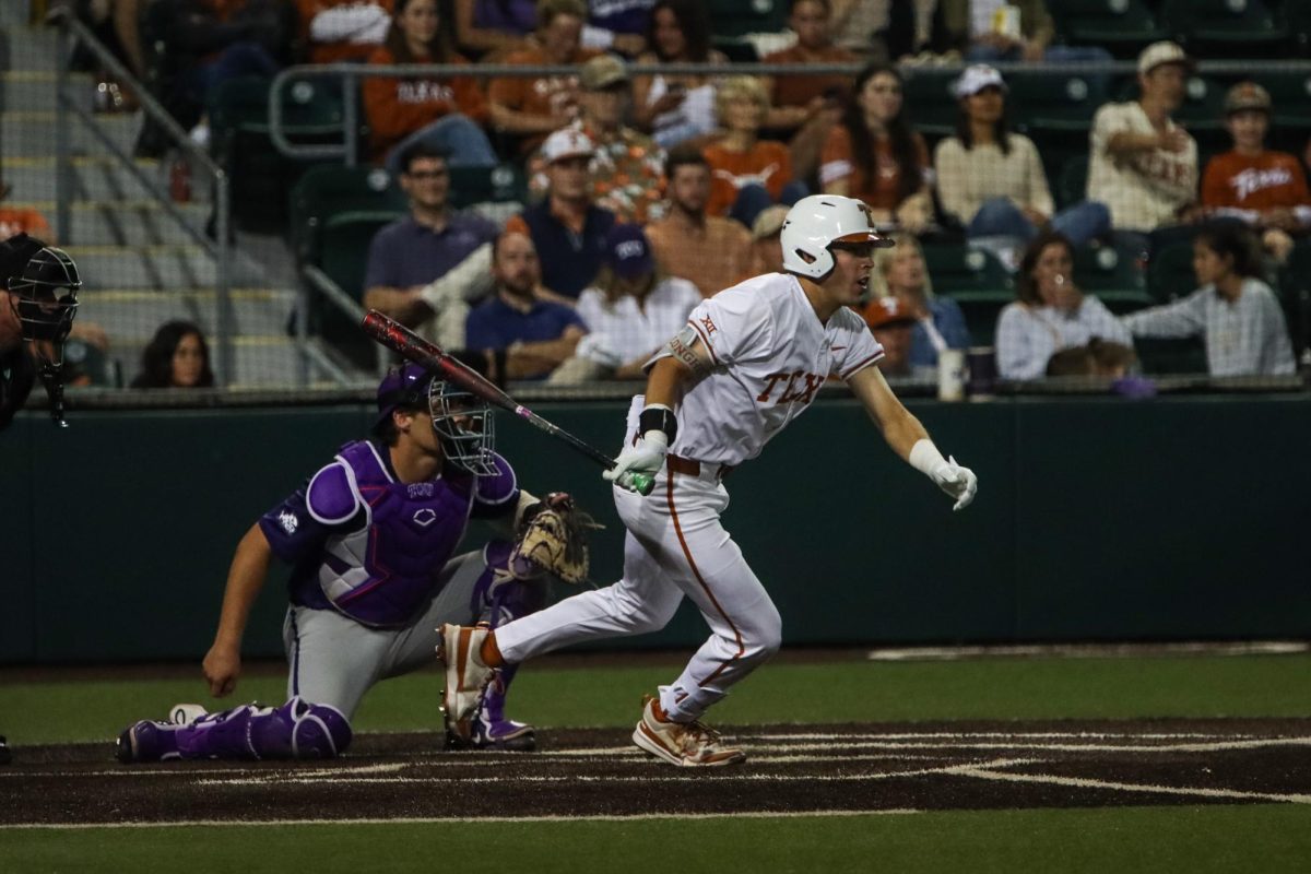 Senior Peyton Powell drops his bat and runs towards first base during Texas’ game against TCU on Friday. The Longhorns lost to the Horned Frogs 5-0.