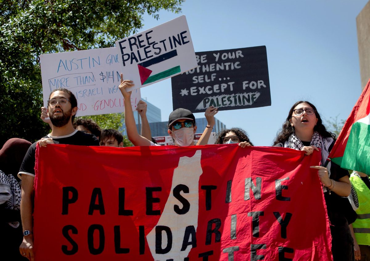 Protesters wield signs and chant slogans in response to Texas Hillel’s 24th Annual Israel Block Party at Speedway Plaza on April 2, 2024.