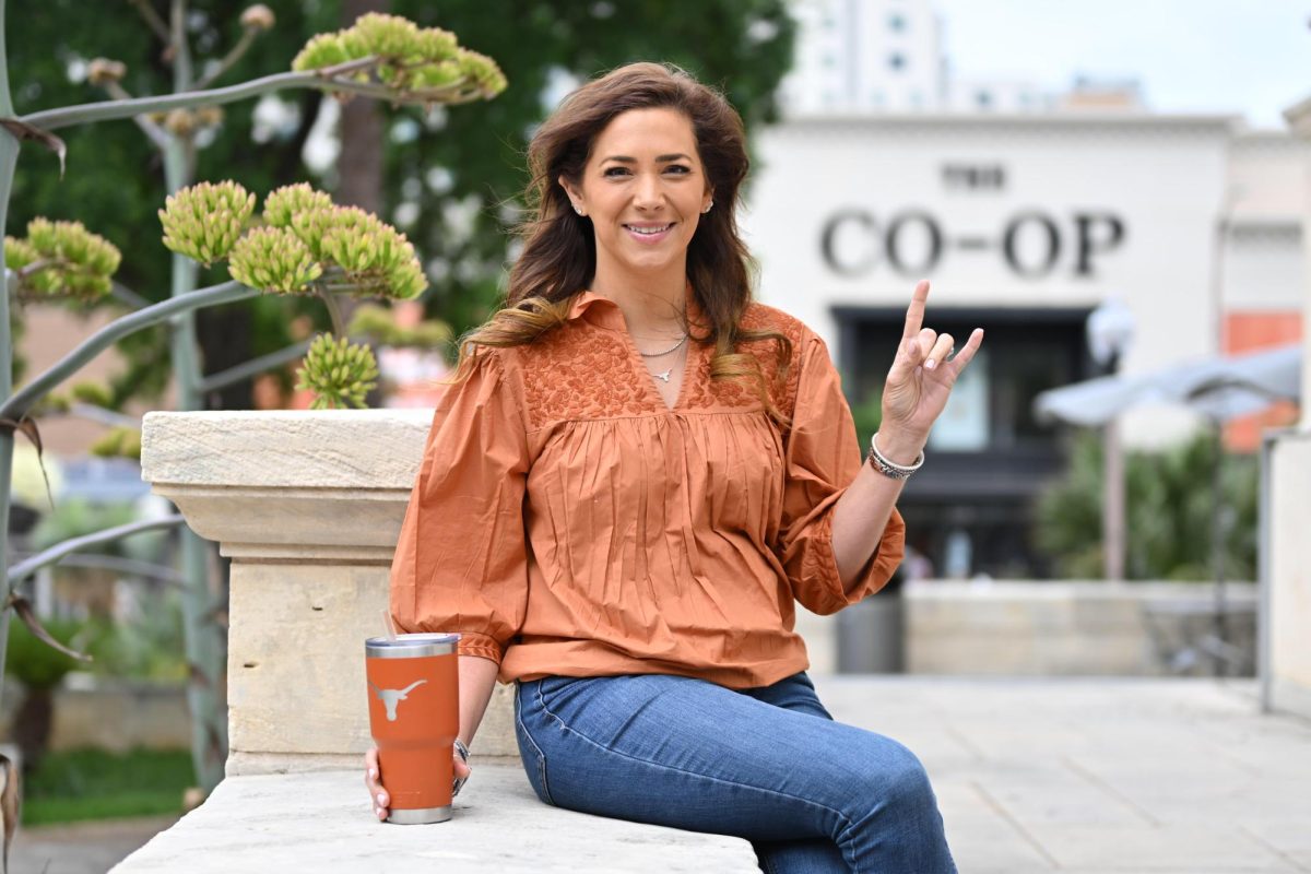 EmilyAnne Skinner sits for a portrait in front of the Texas Union building on Tuesday. Ms. Skinner is the owner of the Burnt Orange Buys, an instagram account that post burnt orange merchandise and inspiration.