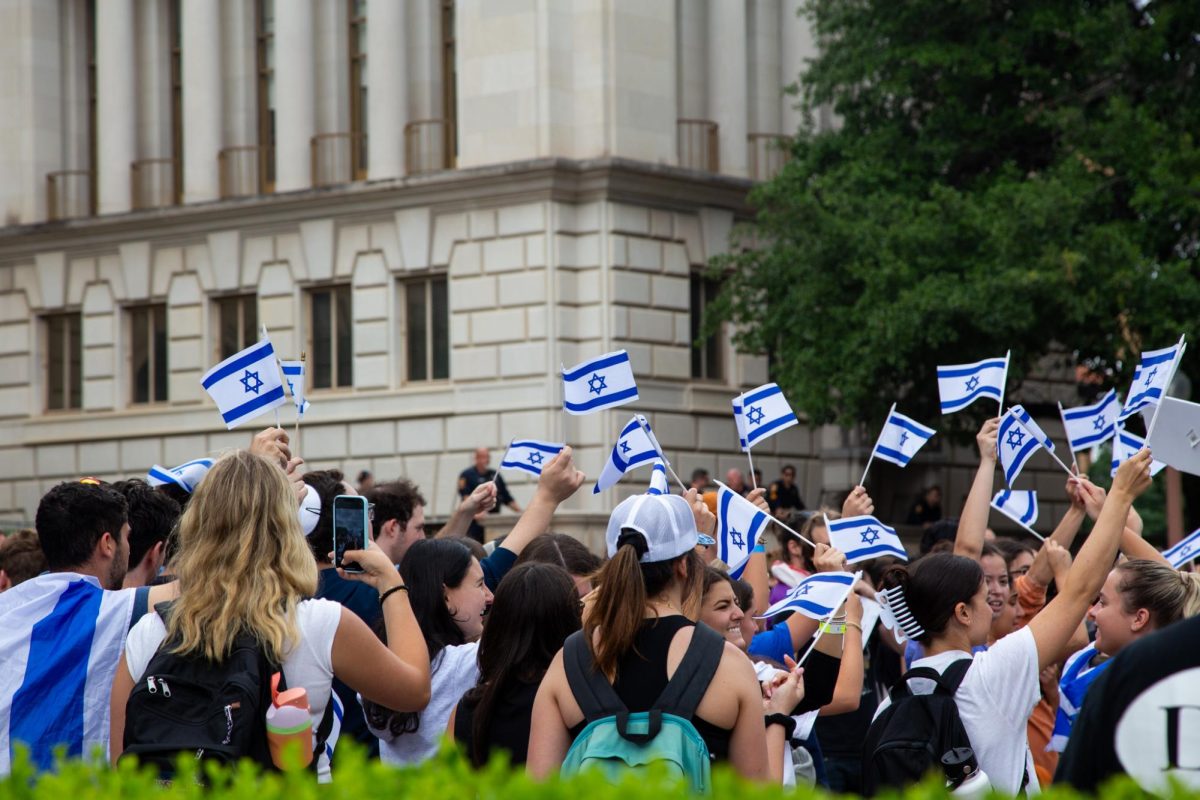 People wave Israel flags to protest a teach in, organized by Faculty and Staff for Justice in Palestine, on April 25, 2024. 