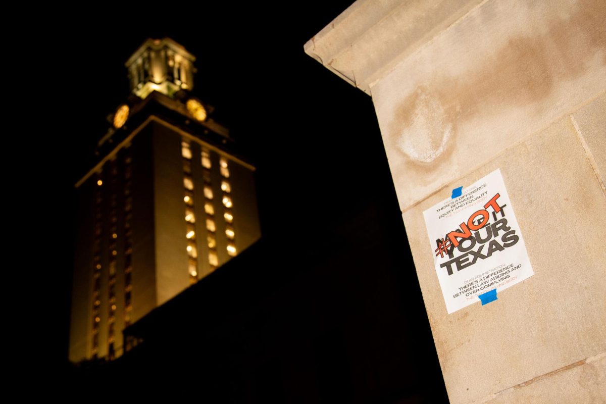 A Not Our Texas sign is pictured in front of the UT Tower on April 4, 2024. Students posted hundreds of flyers on campus and West Campus past midnight.